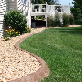 Curbscape - a view of a lawn and a house - Landscaping Near Me