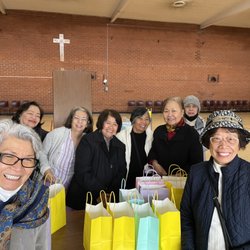 Filipino women of St Dominic's sharing breakfast with everyone early in the morning (6:00am)