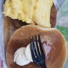 a breakfast of pancakes, eggs, and a fork
