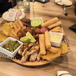 Quintaesencia - Parrillada - grilled steak and chicken, fried pork belly, chorizo, fried cheese, yuca, tostones, french fries & house-made dipping sauces.