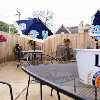 Coasters - a patio with tables and chairs - Bars Near Me - Racine, Wisconsin