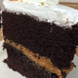 Large slice of chocolate cake with dulce de leche filling. Large slice of chocolate cake with dulce de leche filling.