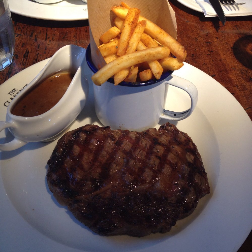 Medium-rare ribeye with skinny fries and steak sauce