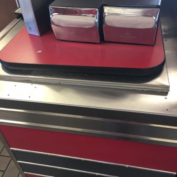 Carl's Jr - a red counter top with three pans on it - Fast Food Near Me - Chico, California
