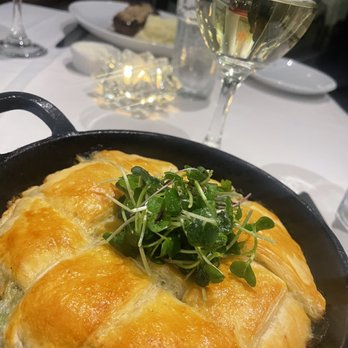 Bloomsbury Bistro - Chicken Pot Pie with micro greens, glass of Riesling - New American Near Me - Raleigh, North Carolina Bloomsbury Bistro - Chicken Pot Pie with micro greens, glass of Riesling - New American Near Me - Raleigh, North Carolina
