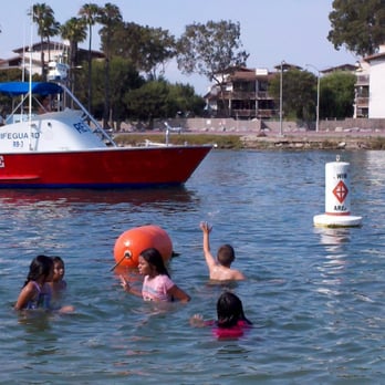 Mother's Beach - Kid waving a life guard boat. - Parks Near Me - Long Beach, California