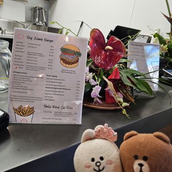 Big Island Burger - Menu next to a beautiful floral arrangement - Burgers Near Me - Urban Honolulu, Hawaii