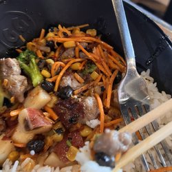 Genghis Grill - My daughters is so different than mine! This is white rice bowl with steak, potato, carrot, black beans and corn mix, sweet and sour sauce.