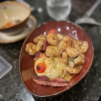 Curio Bistro - Shrimp and jalepeno grits with andouille sausage - Cajun/Creole Near Me - New Orleans, Louisiana