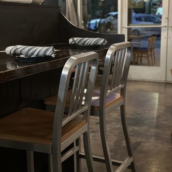 The Magpie - Cute inside with tables and chairs as well as bar seat; seating looking into the kitchen. - New American Near Me - San Antonio, Texas The Magpie - Cute inside with tables and chairs as well as bar seat; seating looking into the kitchen. - New American Near Me - San Antonio, Texas