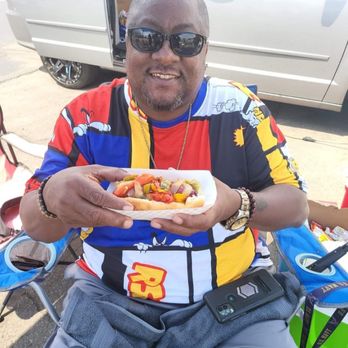 M&M BBQ - a man holding a hot dog - Barbeque Near Me M&M BBQ - a man holding a hot dog - Barbeque Near Me