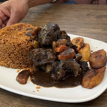 Lagz Restaurant - Oxtail stew with plantains and jollof rice. - African Near Me - Charlotte, North Carolina Lagz Restaurant - Oxtail stew with plantains and jollof rice. - African Near Me - Charlotte, North Carolina