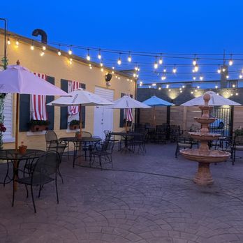 De Vine - a patio area with tables and umbrellas - Wine Bars Near Me - Villa Park, Illinois