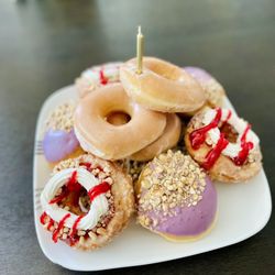 Krispy Kreme - Berry Lovers Dozen. Arranged into a birthday pile by the wifey. Candle not included