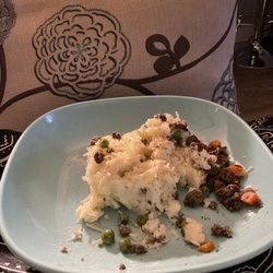 O'Malley's Irish Pub - Shepherd's Pie poured onto a plate out of the cup.