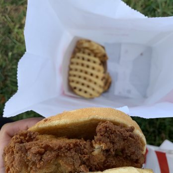 Chick-fil-A - ows a hand holding a fried chicken sandwich - Fast Food Near Me - Sunnyvale, California Chick-fil-A - ows a hand holding a fried chicken sandwich - Fast Food Near Me - Sunnyvale, California