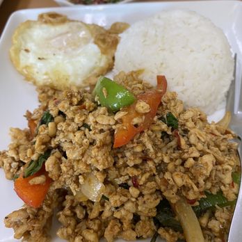 Thai Spice - Hot basil with Chicken - A Thai dish featuring stir-fried ground chicken with basil, served with white rice, a fried egg, and a small bowl of sauce. - Thai Near Me - Hamden, Connecticut