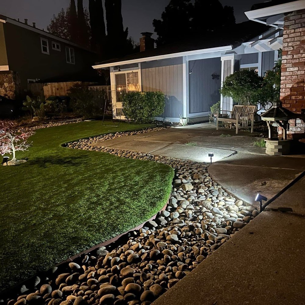 Front yard turf, rock border, and tree Front yard turf, rock border, and tree