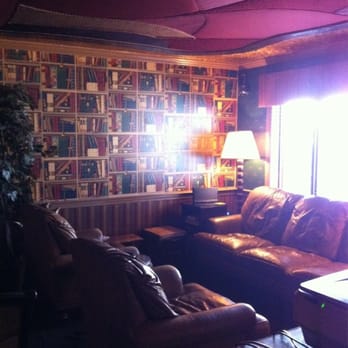 Puff the Magic - a living room filled with books - Lounges Near Me - Hyannis, Massachusetts