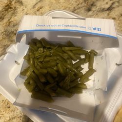 Side of green beans put in a box that leaked through the box and bag.