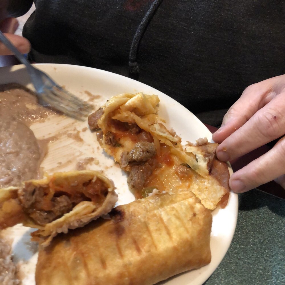 Amigos Mexican Restaurant - Innards of the chimichanga.. beef tips. Not recommended. Maybe ground beef would be a better choice. - Mexican Near Me - Springfield, Missouri