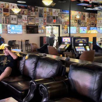 Bourbon Street - a man sitting on a couch in a bar - Sports Bars Near Me - Carson City, Nevada