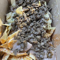 Chilakil To Go - Chilaquiles with carne asada, beans, cilantro, cotija & Monterey Jack cheese.