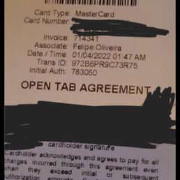 20% service fee, not a 227% increase. - A receipt from Charlie's Chicago restaurant showing payment information, date, and a signature line, with some details blacked out.