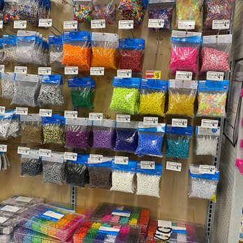 Michaels - A variety of beads in different colors, shapes, and sizes are arranged on a display wall and in containers at Michaels craft store in Chicago, IL. - Knitting Supplies Near Me - Chicago, Illinois