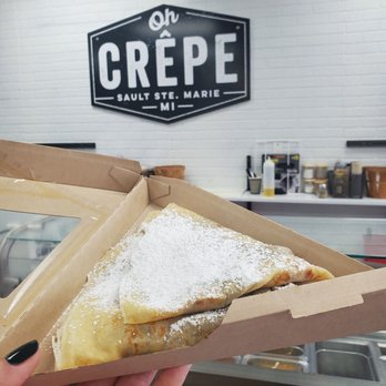 Oh Crêpe and Coffee - a hand holding a piece of pastry - Creperies Near Me - Sault Ste. Marie, Michigan Oh Crêpe and Coffee - a hand holding a piece of pastry - Creperies Near Me - Sault Ste. Marie, Michigan