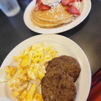 The Pancakery - 2 eggs scrambled well, sausage, grits, silver pancakes added strawberry and whip topping - Breakfast & Brunch Near Me - Destin, Florida
