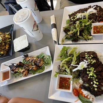 Hye Thai - Left to right: Curry Fried Rice, side of vermicelli noodles, chicken satay, and two of the crying tigers. - Thai Near Me - Stonewall, Texas