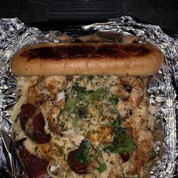 a hot dog with broccoli and cheese