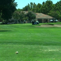 Rancho Del Pueblo Golf Course - Threesome sharing 1 set of clubs, 1 cart, parked on the fringe.