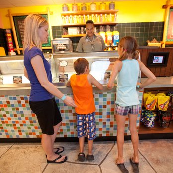 Bear Claw Cafe - a woman and two children at the counter - Desserts Near Me - Niagara Falls, Ontario Bear Claw Cafe - a woman and two children at the counter - Desserts Near Me - Niagara Falls, Ontario