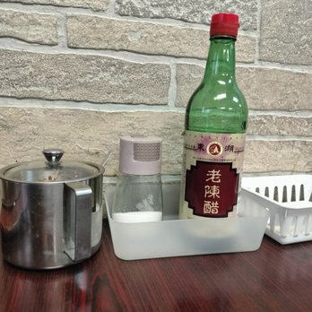Xi An Gourmet - Table condiments: A metal pot of chilies in oil, salt, and a bottle of aged vinegar (the good stuff!) Xian Gourmet/ Buffalo. - Chinese Near Me - Buffalo, New York Xi An Gourmet - Table condiments: A metal pot of chilies in oil, salt, and a bottle of aged vinegar (the good stuff!) Xian Gourmet/ Buffalo. - Chinese Near Me - Buffalo, New York