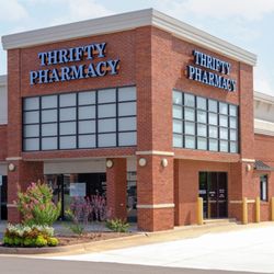 Thrifty Pharmacy-Edmond - This photo shows a modern brick building housing Thrifty Pharmacy. The pharmacy signage is displayed prominently in bold blue...