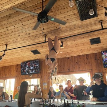 Undertow Beach Bar - a man hanging upside down from a ceiling fan - Bars Near Me - St. Pete Beach, Florida Undertow Beach Bar - a man hanging upside down from a ceiling fan - Bars Near Me - St. Pete Beach, Florida