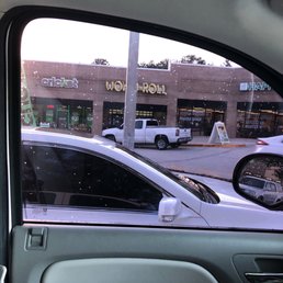 ows a view of a parking lot from inside a car