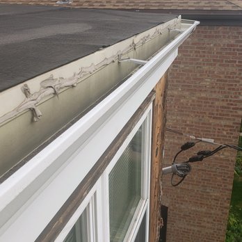 Home Improvement Guyz - More caulking used to hold together the old gutters that they cut and tried to piece together to a piece of a new one. And no flashings. - Windows Installation Near Me - Wood Dale, Illinois Home Improvement Guyz - More caulking used to hold together the old gutters that they cut and tried to piece together to a piece of a new one. And no flashings. - Windows Installation Near Me - Wood Dale, Illinois