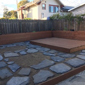 Noma Land Designs - Flagstones laid out before setting them in the ground. - Landscaping Near Me Noma Land Designs - Flagstones laid out before setting them in the ground. - Landscaping Near Me