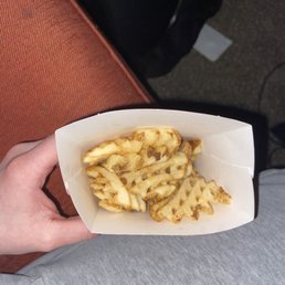 ows a person holding a basket of fries ows a person holding a basket of fries