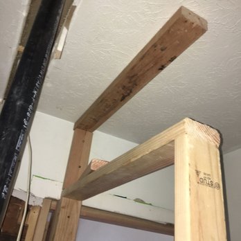 Superior Home Service - a wooden beam in the middle of a room - General Contractors Near Me - Hartland, Michigan Superior Home Service - a wooden beam in the middle of a room - General Contractors Near Me - Hartland, Michigan