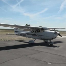A Cessna parked and tied down at the parking area and next to the 24 hour fuel pumps - Harris Ranch Airport (3O8).