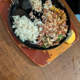 My Wife (who is a Full Filipina), their sisig was a beautiful presentation, served with chicharon and a raw egg on an iron skillet. My Wife (who is a Full Filipina), their sisig was a beautiful presentation, served with chicharon and a raw egg on an iron skillet.