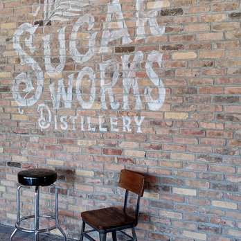Sugar Works Distillery - two stools against a brick wall - Distilleries Near Me - New Smyrna Beach, Florida Sugar Works Distillery - two stools against a brick wall - Distilleries Near Me - New Smyrna Beach, Florida