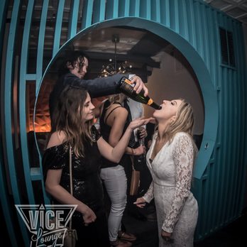 VICE Lounge + Mojito Bar - a woman pouring champagne into a bottle - Bars Near Me - Savannah, Georgia VICE Lounge + Mojito Bar - a woman pouring champagne into a bottle - Bars Near Me - Savannah, Georgia