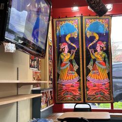 Bombay Curry - TV playing videos and window decorations.