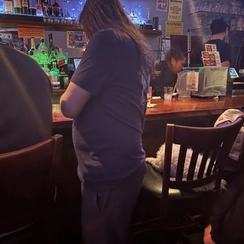 Asia Roma - Owner's dog laying on a bar stool near patrons. - Karaoke Near Me - New York, New York Asia Roma - Owner's dog laying on a bar stool near patrons. - Karaoke Near Me - New York, New York