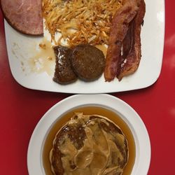 Poor Girls Cafe - Poor Girl Special with Scrambled Eggs comes with all 3 meats, Bacon,Sausage and Ham and 2 sides I got Hash browns and a Pancake